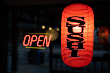 Sushi Lantern With Open Sign Illuminated in Background - 215197272