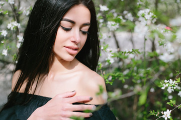 Portrait close up of young beautiful woman, on green background summer nature.Beauty Woman face Portrait. Beautiful Spa model Girl with Perfect Fresh Clean Skin. Brunette female 