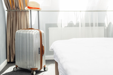 suitcase in light hotel room