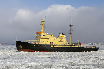 Fototapeta premium Icebreaker ship vessel in ice tries to break between the glaciers