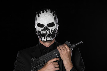 man in a black mask with a gun