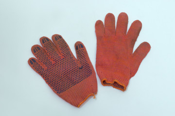 work gloves of orange-red cotton. one is turned inside out. pair with stretchable cuff with bright orange hem. clipping path