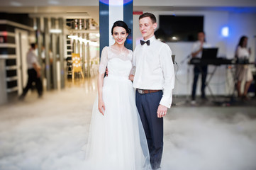 Romantic newly married couple performing their first dance in the restaurant.