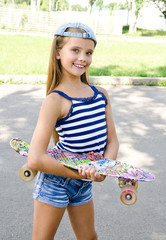 Adorable happy smiling  little girl child with skateboard outdoors © svetamart
