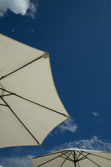 Beach umbrella under the blue sky / Looking at view. Copy space