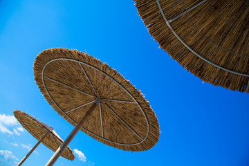 Fototapeta premium Wooden beach umbrella / Enjoying summer vacation. Copy space