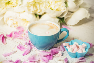 Coffee with milk and flowers white peonies. The atmosphere of relaxation. 
