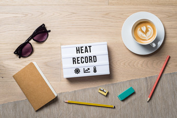 Heat record written on light box as flat lay from above on office desk
