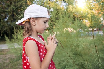 Fototapeta premium Little girl saying his prayers . Inner world of the child . spiritual education . Prayer hands and cross . 
