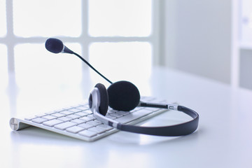 Call center and customer service help desk. VOIP headset on laptop computer keyboard