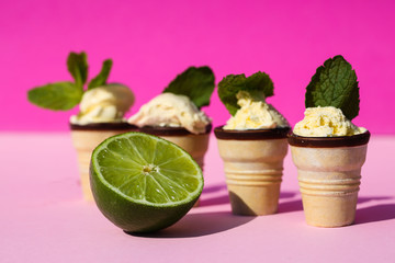 Ice cream in waffle with mint leaves, pink background