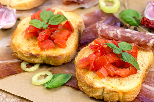 Tomato bruschetti -bruschetta and prosciutto, sausage like delicious meal