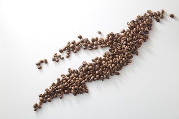 roasted coffee beans poured from clear glass