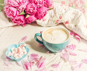 Obraz na płótnie Canvas Coffee with milk and flowers pink peonies. The atmosphere of relaxation. 