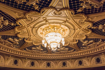 Chandelier on the ceiling. The building is in the style of the French Renaissance. Renaissance in...