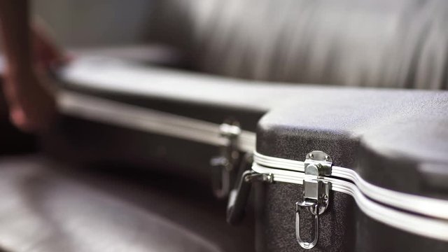 The girl takes out the guitar from the case
