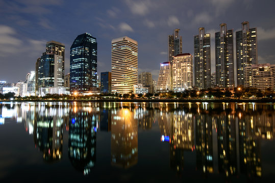 Modern buildings with lights reflection of Benchakitti Park