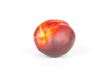 One whole ripe deep red nectarine isolated on white