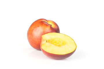 Group of one whole one half of ripe deep red nectarine isolated on white