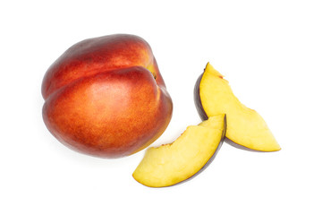 Group of one whole two slices of ripe deep red nectarine flatlay isolated on white