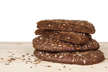 Rye bread with sunflower seeds and flax on a wooden table