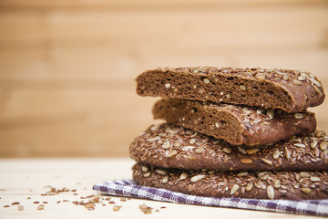 Rye bread with sunflower seeds and flax on a wooden table