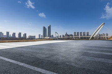 Obraz premium Panoramic skyline and modern business office buildings with empty road,empty concrete square floor