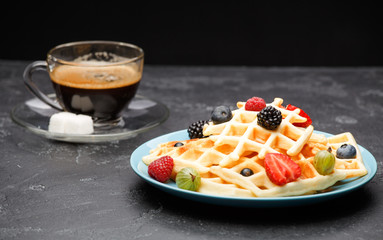 Photo of cup of coffee with Belgian wafers with strawberries, raspberries