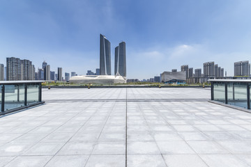 Obraz premium Panoramic skyline and modern business office buildings with empty road,empty concrete square floor
