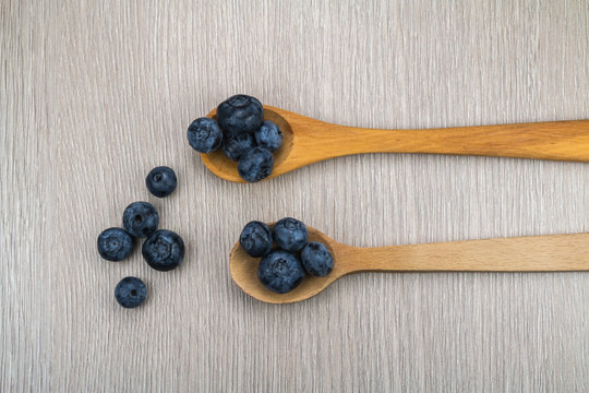 Blueberries in spoons on table