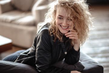 Obraz premium Close-up portrait of sexy blonde woman in a black leather jacket and lacy bra, fashion beauty photo