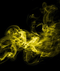 Fototapeta premium Yellow smoke on black background