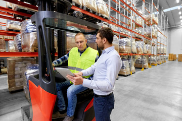 logistic business, shipment and people concept - warehouse worker and businessman with tablet pc...