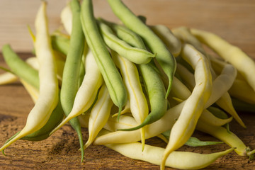 Fresh raw beans on a wooden background