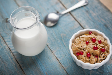 White bowl with corn cereals oatmeal flakes