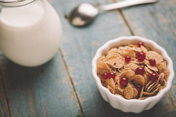 White bowl with corn cereals oatmeal flakes