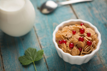 White bowl with corn cereals oatmeal flakes