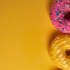 Yellow and pink donut on a yellow copy space