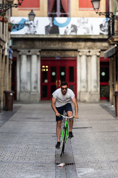 Man on bicycle riding on alley