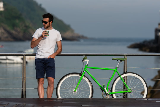 Man with coffee at bicycle