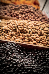Almonds and dried aronia berries on farmer’s market / Heap of dried fruit on marketplace
