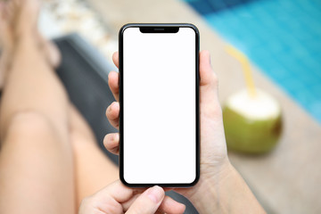 woman by the pool holding phone with isolated screen