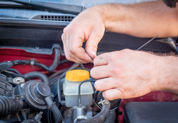 repair and maintenance of the car, men's hands hold technical car engine service
