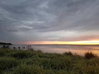 sunset storm clouds over pier