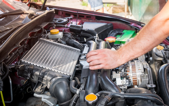 repair and maintenance of the car, men's hands hold technical car engine service