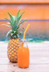 Fresh yellow pineapple tropic fruit summer refreshment smoothie shake drink near pool
