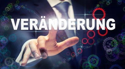 A businessman pressing a Change 