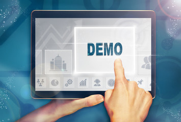 A hand selecting a demo business concept on a computer tablet screen with a colorful background.