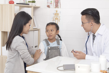 Doctor talking to young child and mother