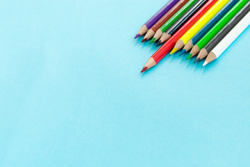 Education or back to school Concept. Close up shot of color pencil pile pencil nibs on blue background with copy space